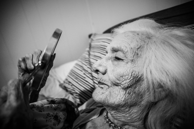 Grandma studies herself in the mirror.