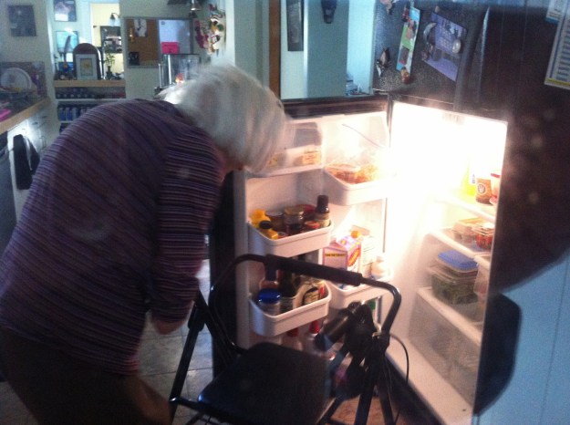 Grandma gets into the refrigerator as seen from my  new home office (which has a window into the kitchen).
