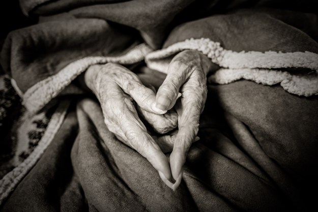 Grandma makes a heart.