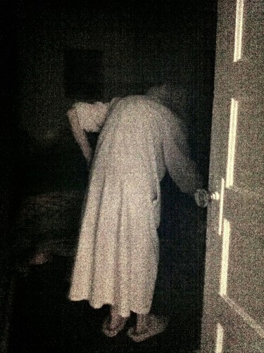 Grandma disappears into her room on the way to bed.